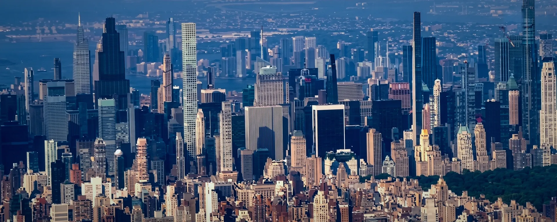 Midtown Manhattan from the air, towers of high-value apartments stepping up toward the edge of Central Park.